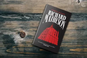 Book cover of Hell House by Richard Matheson on dark wooden surface