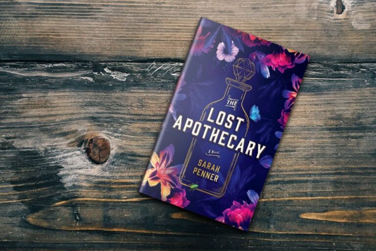The Lost Apothecary by Sarah Penner lying on a wooden surface