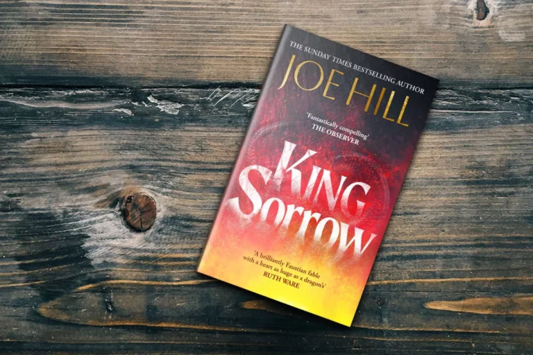 King Sorrow by Joe Hill Book on wooden Table