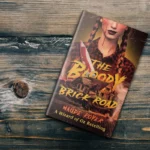 The Bloody Brick Road Book on an old wooden table.